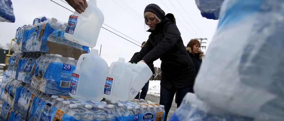 Volunteers distribute bottled water to help combat the effects of the crisis when the city's drinking water became contaminated with dangerously high levels of lead in Flint