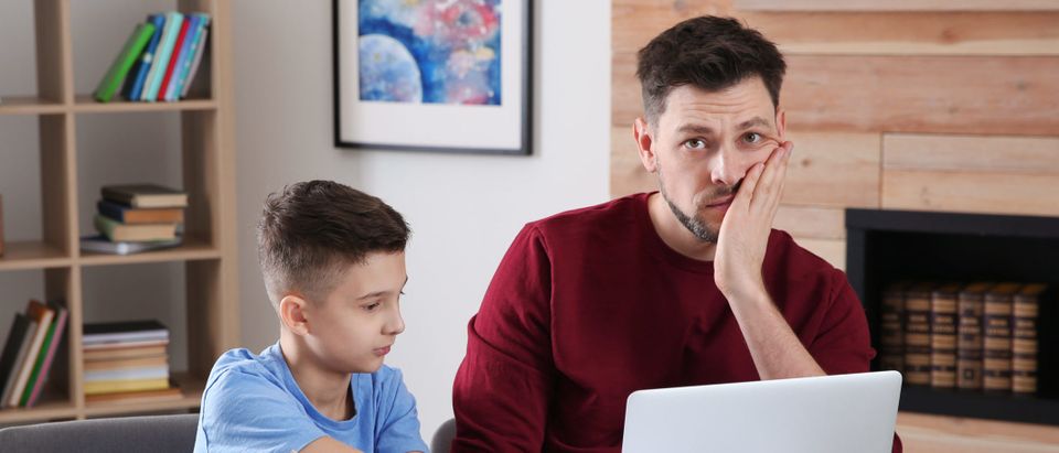 Dad,Helping,His,Son,With,Difficult,Homework,Assignment,In,Room,