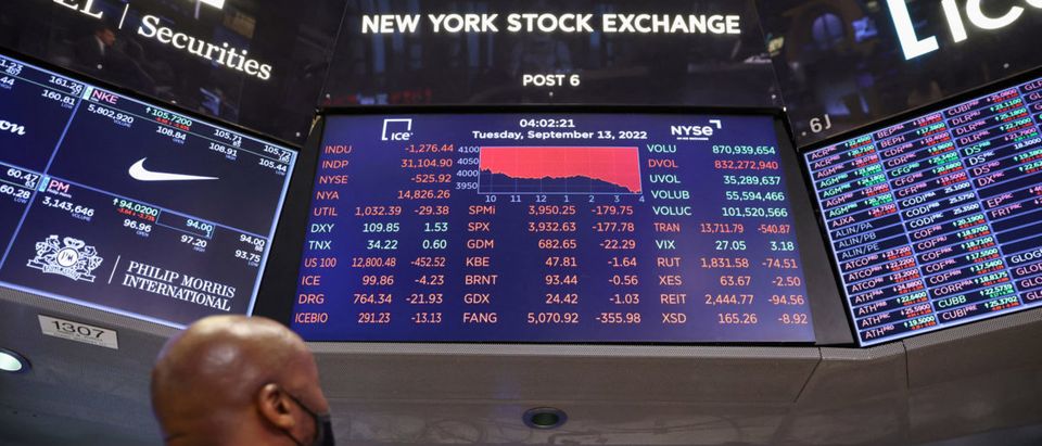 A trader looks at a screen showing the Dow Jones Industrial Average on the trading floor at the New York Stock Exchange (NYSE) in Manhattan, New York City