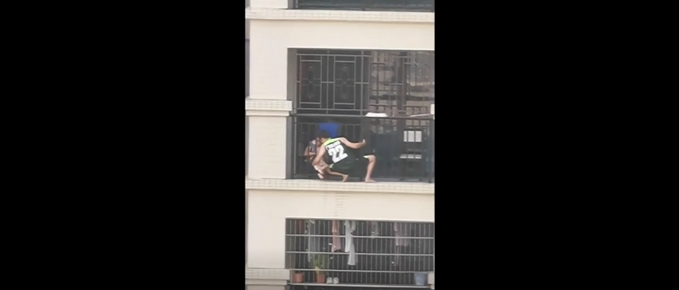 Man rescues child dangling from building in China, TMZ