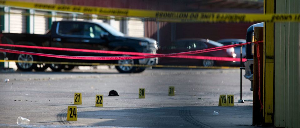 The scene of a shooting is pictured behind police yellow tape after two people were killed and three more critically injured in a shooting at a flea market in Houston, Texas on May 15, 2022. - Two people were killed and three more were taken to a hospital with injuries after a shooting May 15, 2022 at a bustling Houston flea market, authorities said. (Photo by MARK FELIX/AFP via Getty Images)