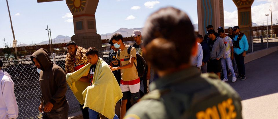 Migrants turn themselves in to U.S. Border Patrol agents after crossing into the United States from Mexico, in El Paso