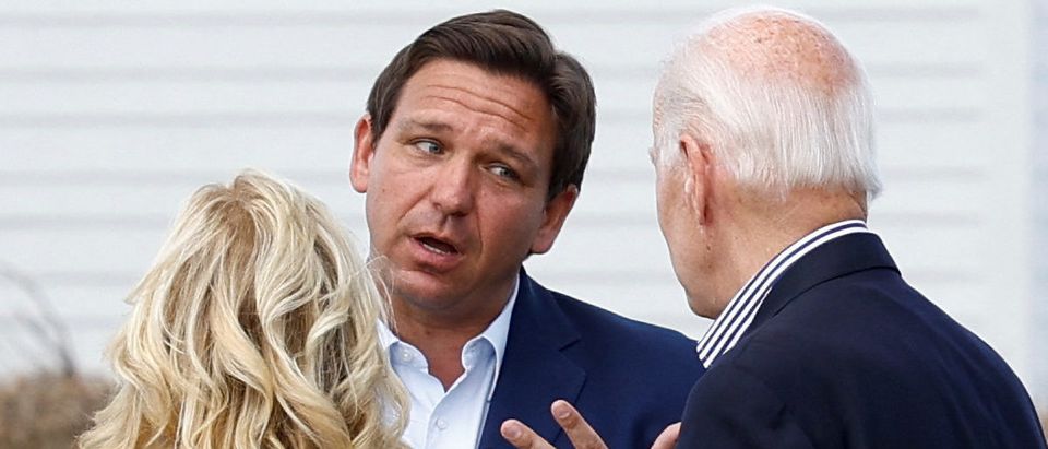 U.S. President Joe Biden and first lady Jill Biden speak with Florida Governor Ron DeSantis as they tour Hurricane Ian destruction during a visit to Florida, in Fort Myers Beach, Florida, U.S., October 5, 2022. REUTERS/Evelyn Hockstein