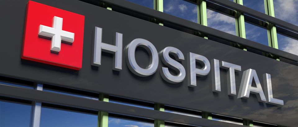 Hospital,Building,Sign,Closeup,,With,Sky,Reflecting,In,The,Glass.