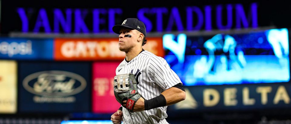 Aaron Judge #99 of the New York Yankees runs to the dugout after the fifth inning against the Houston Astros in game four of the American League Championship Series at Yankee Stadium on October 23, 2022 in the Bronx borough of New York City. (Photo by Elsa/Getty Images)