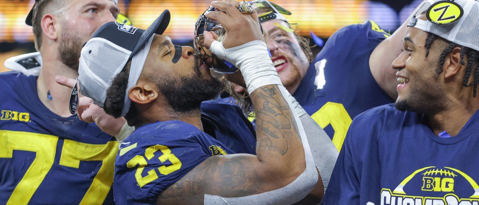 Michael Barrett #23 of the Michigan Wolverines kisses the Big Ten trophy following the game against the Purdue Boilermakers in the Big Ten Championship at Lucas Oil Stadium on December 4, 2022 in Indianapolis, Indiana. (Photo by Michael Hickey/Getty Images)