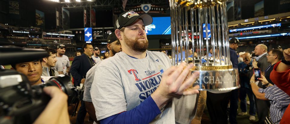 Jordan Montgomery #52 of the Texas Rangers celebrates with the Commissioner's Trophy after the Texas Rangers beat the Arizona Diamondbacks 5-0 in Game Five to win the World Series at Chase Field on November 01, 2023 in Phoenix, Arizona. (Photo by Christian Petersen/Getty Images)